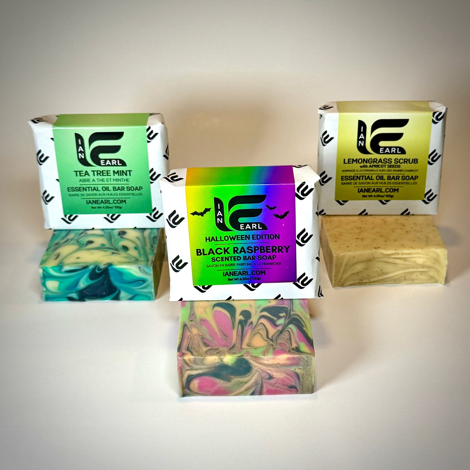 Collection of Ian Earl soap bars and packaging on a neutral background